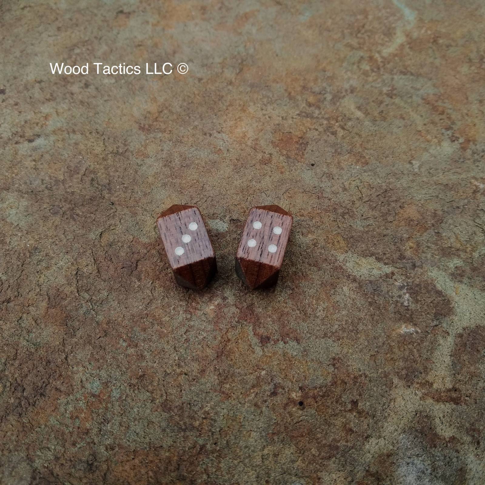 Walnut Hardwood Barrell D4 Dice with Pips Symbols. 

Symbols are inked in white.