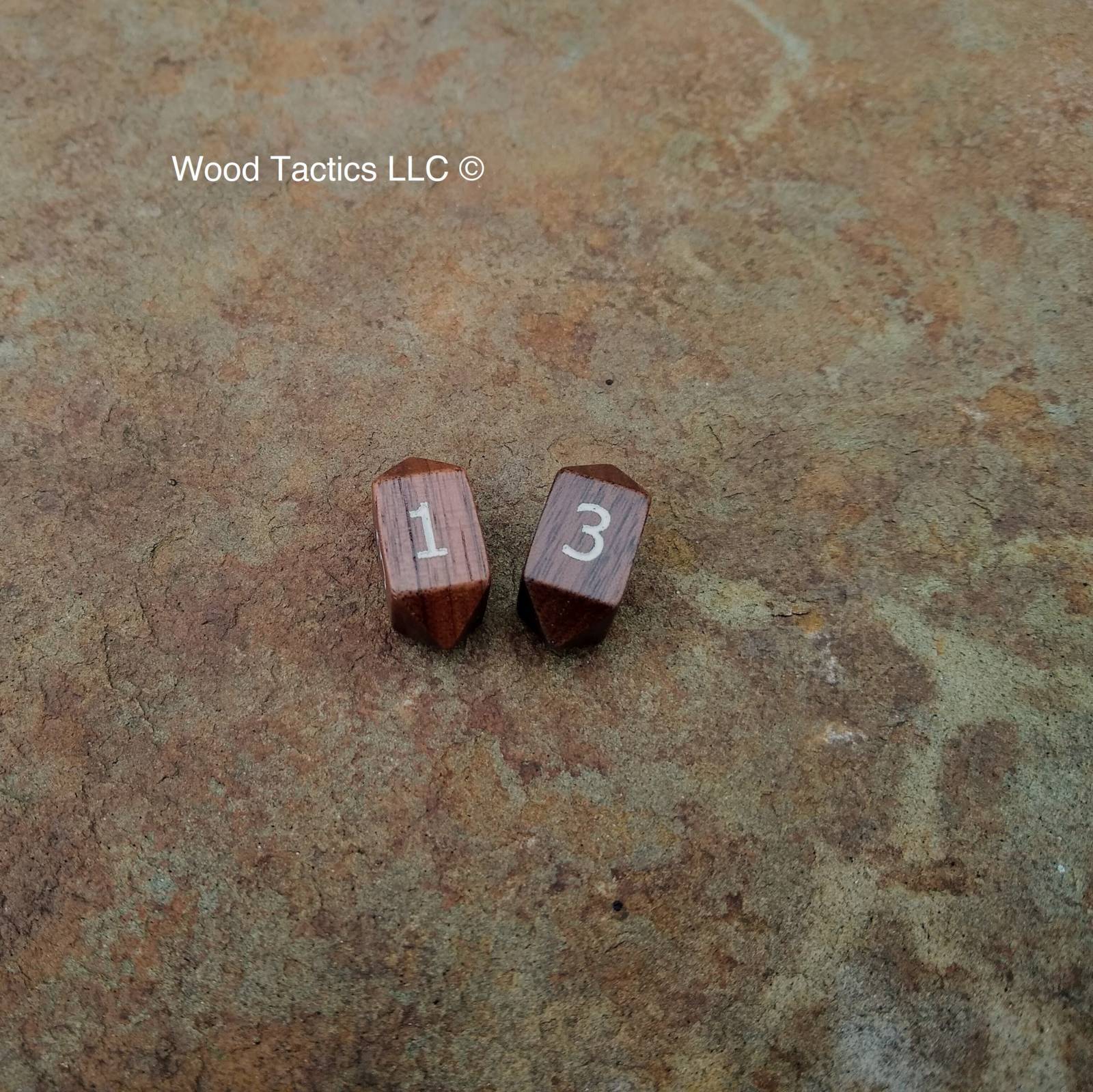 Walnut Hardwood Barrell D4 Dice with Numbers Symbols. Symbols are inked in white.