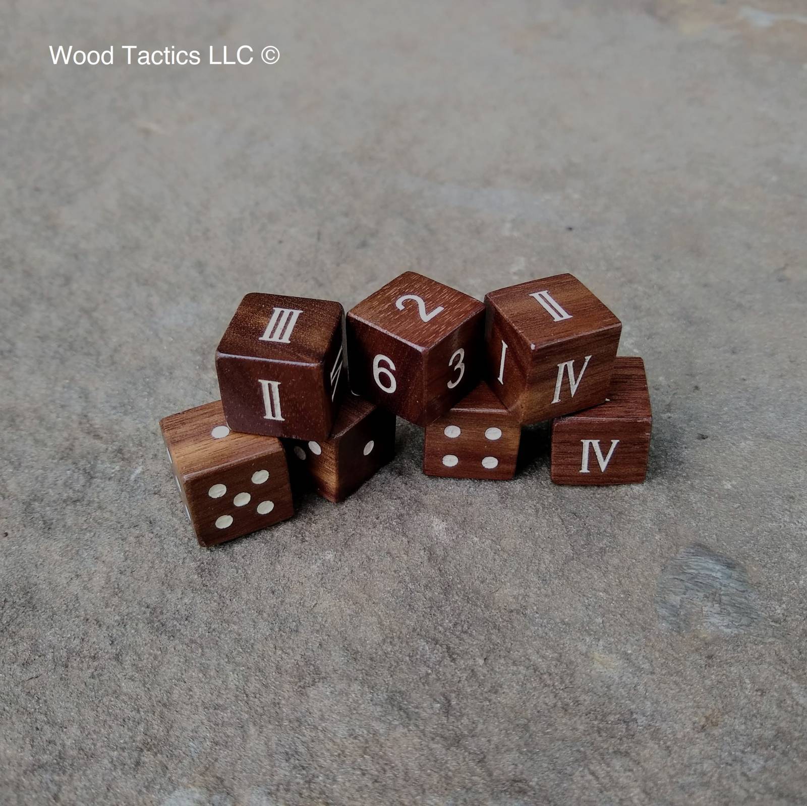 Walnut Hardwood D6 16mm in size Dice with Pips, Numbers, Roman Numerals Symbols. Symbols are inked in white.