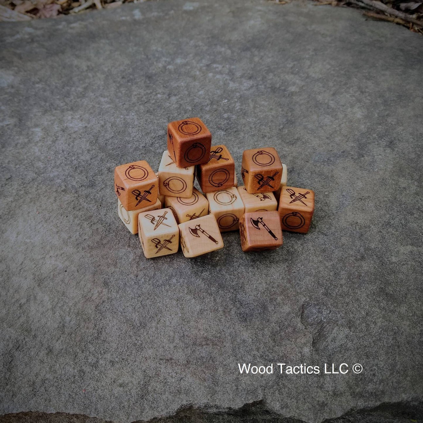 Cherry and Maple Hardwood Mouse Guard Roleplaying game dice with Axe, Ouroboros, and Crossed Dagger Symbols